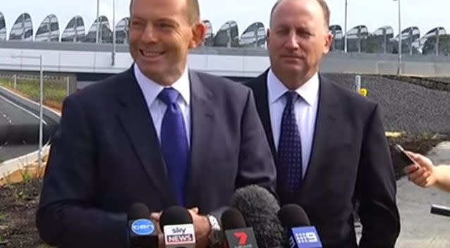 Mr Abbott did not appear too hurt by the passerby. Photo: Screenshot