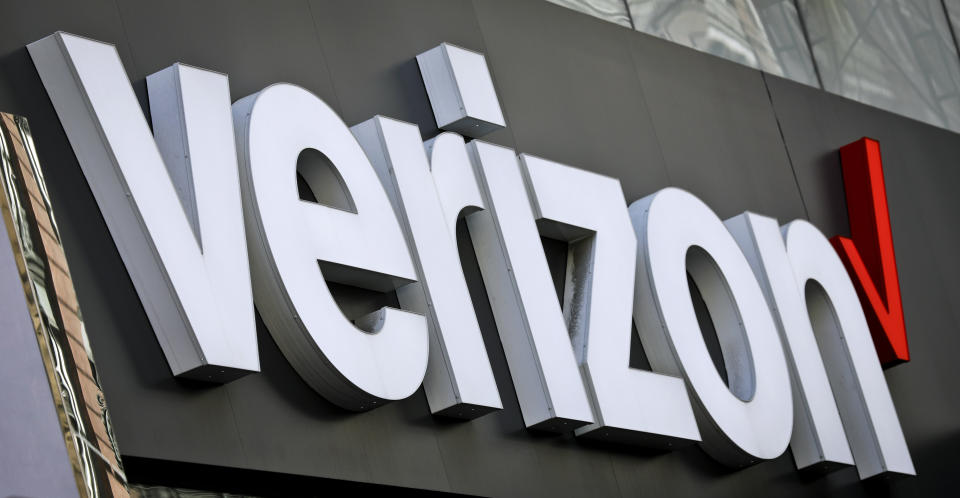 FILE - This May 2, 2017, file photo, shows Verizon corporate signage on a store in New York's Midtown. Shares of Verizon are falling before the opening bell after the company said it would take a $4.6 billion hit for what’s become an expensive internet foray that’s never panned out. (AP Photo/Bebeto Matthews, File)