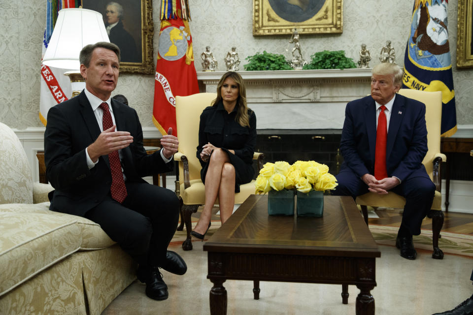 President Donald Trump and first lady Melania Trump listen as acting FDA Commissioner Ned Sharpless talks about a plan to ban most flavored e-cigarettes, in the Oval Office of the White House, Wednesday, Sept. 11, 2019, in Washington. (AP Photo/Evan Vucci)