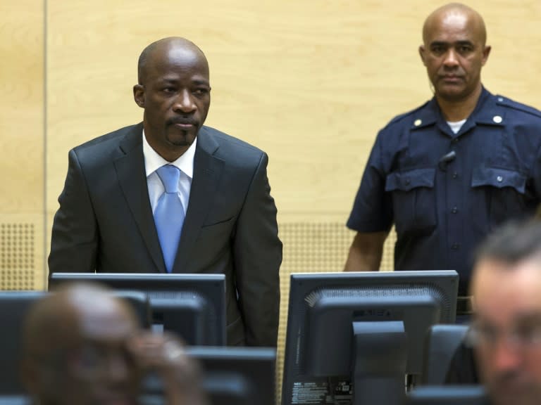 Former Ivorian youth militia leader Charles Ble Goude (left) enters the courtroom of the International Criminal Court (ICC) for his initial appearance in The Hague, on March 27, 2014