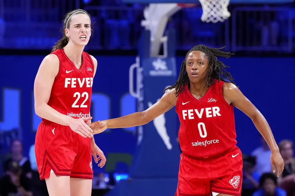 Kelsey Mitchell #0 of the Indiana Fever celebrates scoring with Caitlin Clark #22 in the second half against the Dallas Wings at College Park Center on September 01, 2024 in Arlington, Texas.