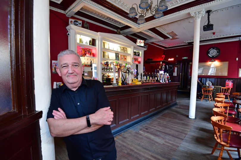 Conor Devlin inside the Vernon Arms pub, with the bar behind him