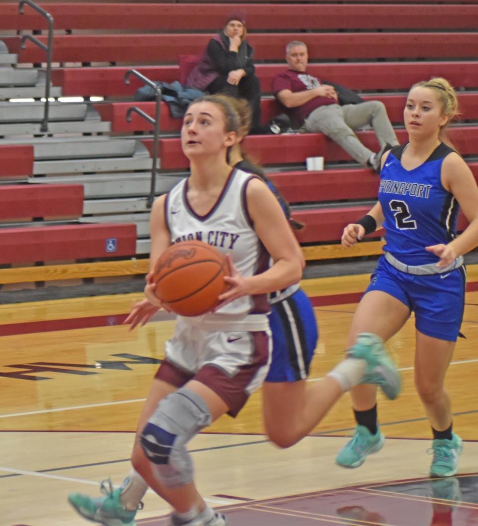 Union City's Jordan Chard coasts in for two on the break while Springport's Chloey Speer trails Thursday night.