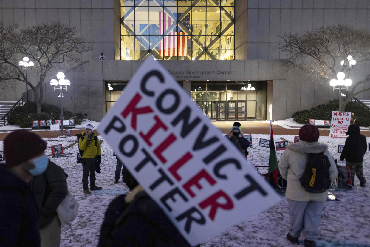 A protester holds a sign demanding a conviction of former Minneapolis police officer Kim Potter on the third day of jury deliberation outside of the Hennepin County Government Center on Wednesday, Dec. 22, 2021, in Minneapolis. Potter, who is white, is charged with first- and second-degree manslaughter in the shooting of Daunte Wright, a Black motorist, in the suburb of Brooklyn Center. Potter has said she meant to use her Taser – but grabbed her handgun instead – after Wright tried to drive away as officers were trying to arrest him. (AP Photo/Christian Monterrosa)