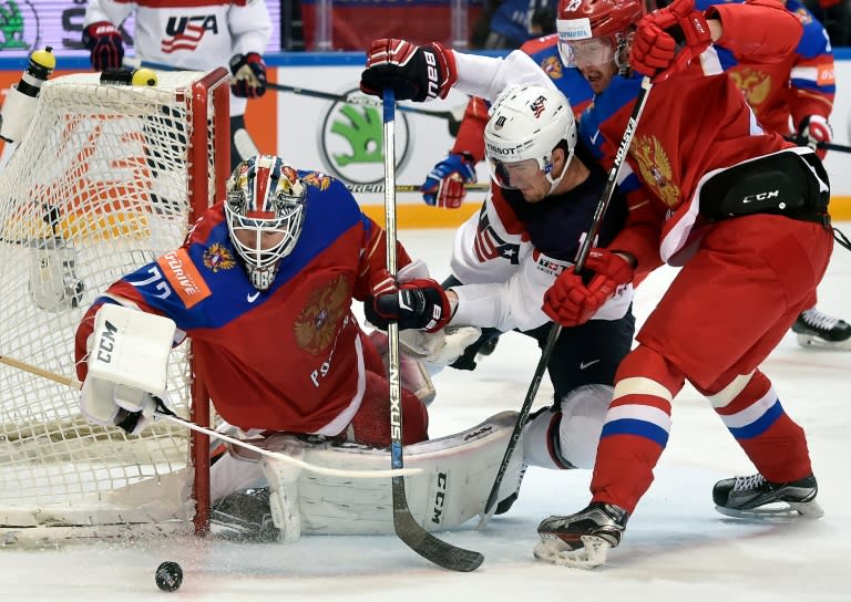 US forward Brock Nelson (C) attacks Russia's goalie Sergei Bobrovski (L) as Russia's forward Roman Lyubimov tries to stop him during the bronze medal game at the 2016 IIHF Ice Hockey World Championship in Moscow on May 22, 2016