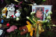 A photo of Caroline Previdi, one of the victims from an elementary school shooting is placed at a makeshift shrine to the victims of an elementary school shooting in Newtown, Connecticut, December 17, 2012. Funerals have began in the town for the 20 children and six staff killed in the massacre