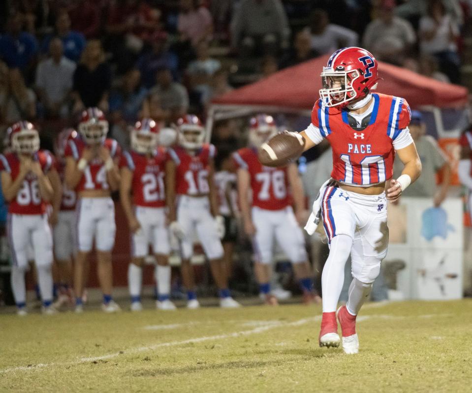 Pace quarterback Nick Simmons (No. 10) pitches out to his running back during Friday night's District 1-4S game against Navarre.