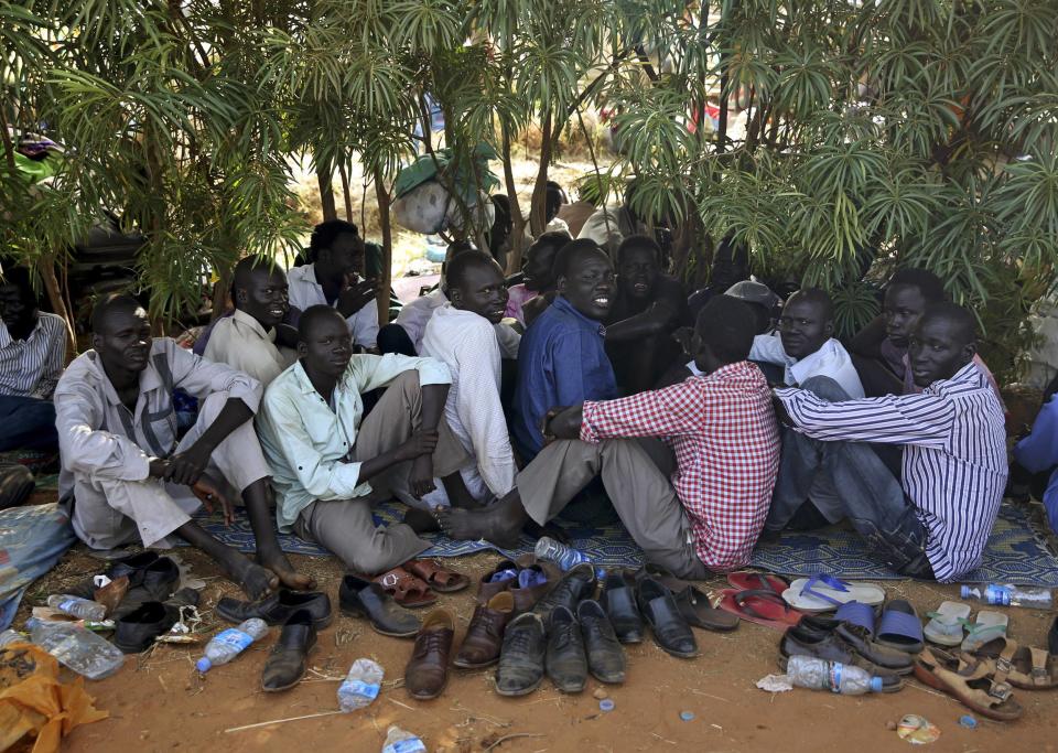 Internally displaced men sit inside a UNMIS compound in Juba