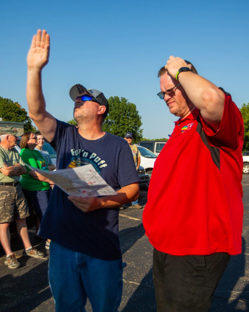 Hot air balloon pilots Tony Goodnow and Michael Scott check wind patterns and maps before picking a site to launch balloons from. Goodnow and Scott were two of four pilots demonstrating hot air balloon operations to media ahead of this weekend's Huff 'n Puff Hot Air Balloon Rally.