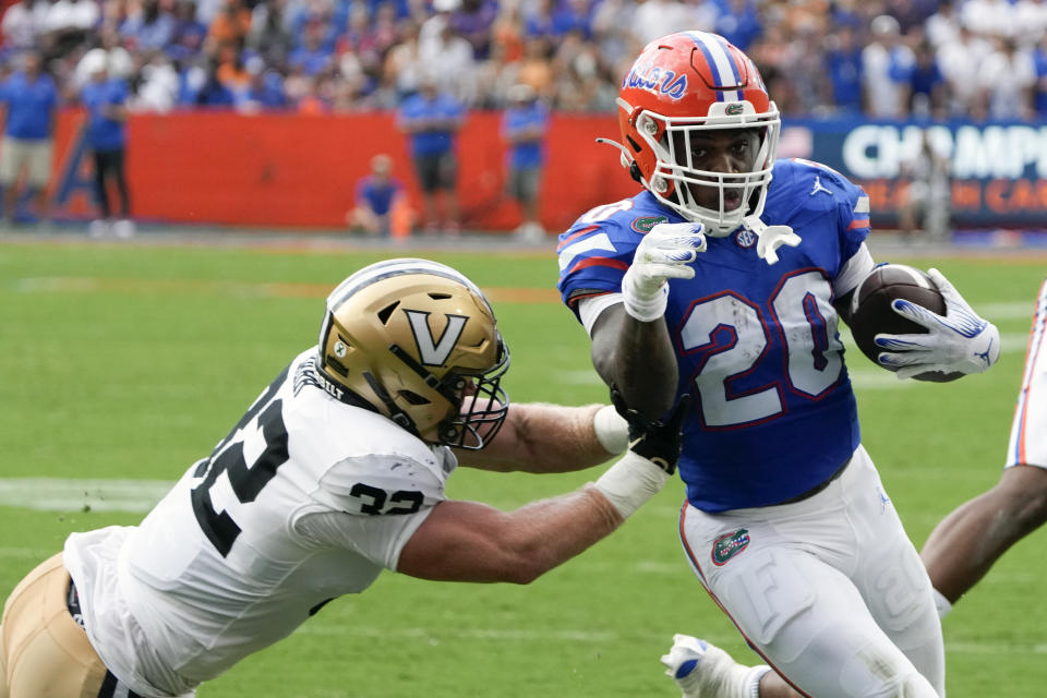 Florida running back Treyaun Webb (20) is pushed out of bounds by Vanderbilt linebacker Ethan Barr, left, during the first half of an NCAA college football game, Saturday, Oct. 7, 2023, in Gainesville, Fla. (AP Photo/John Raoux)