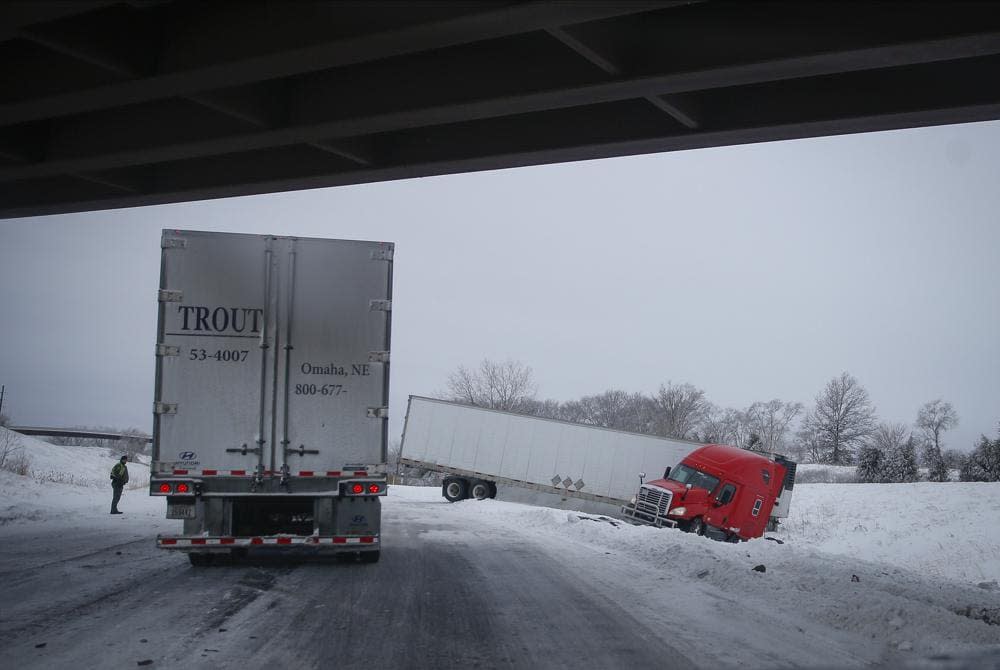 A semi accident holds up traffic on Interstate 80 near Des Moines, Iowa, on Saturday, Jan. 15, 2022, after a winter storm dumped several inches of snow across central Iowa. (Bryon Houlgrave/The Des Moines Register via AP)