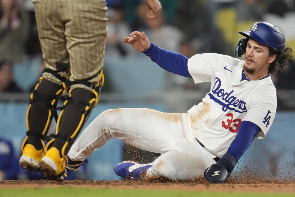 Los Angeles Dodgers' James Outman scores on a single by Mookie Betts during the fourth inning of a baseball game against the San Diego Padres, Saturday, April 13, 2024, in Los Angeles. (AP Photo/Marcio Jose Sanchez)