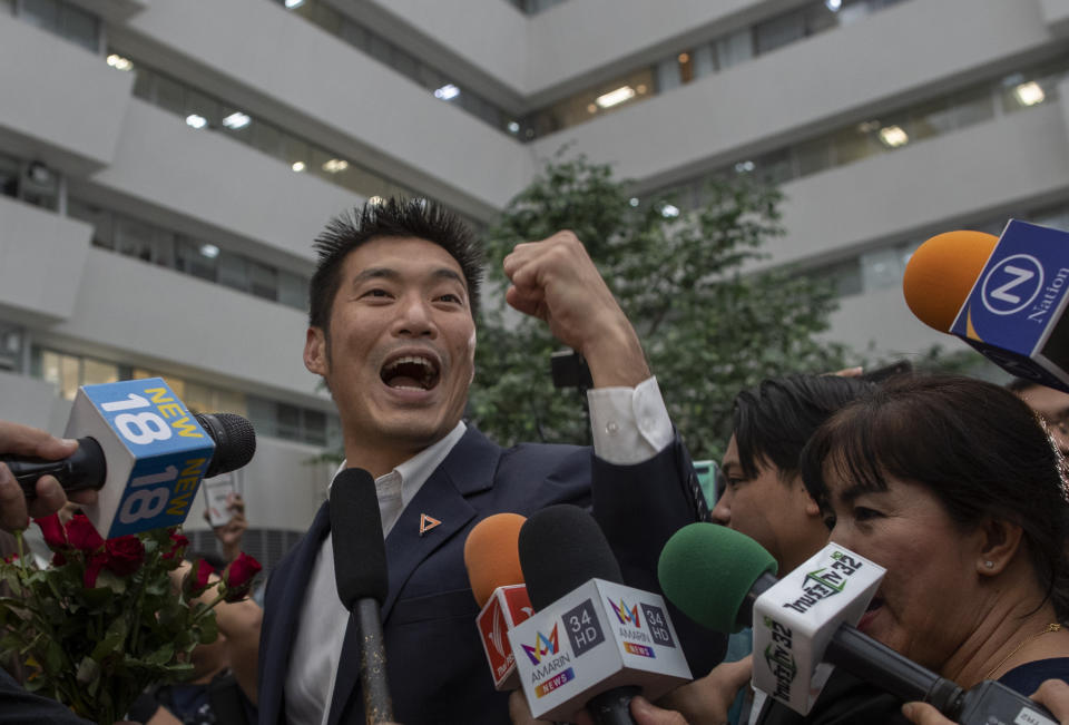 Thanathorn Juangroongruangkit, leader of the anti-military Future Forward Party, gestures as he arrive at the Constitutional Court in Bangkok, Thailand, Wednesday, Nov. 20, 2019. Thanathorn is expected to receive a verdict whether he is eligible to remain as a member of the parliament due to an accusation of owning media shares a violation of the Thai constitution. (AP Photo/Gemunu Amarasinghe)