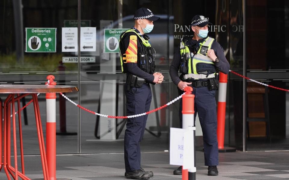 Police stand guard at a hotel in Melbourne - Getty