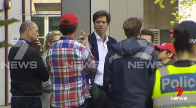 AFL CEO Gill McLachlan was seen speaking with other staffers. Photo: 7 News