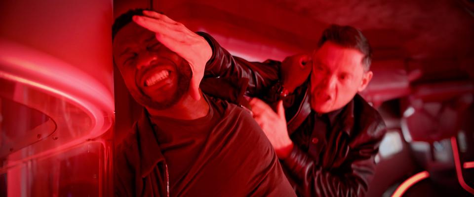 Kevin Hart getting his face pushed against a wall of a plane