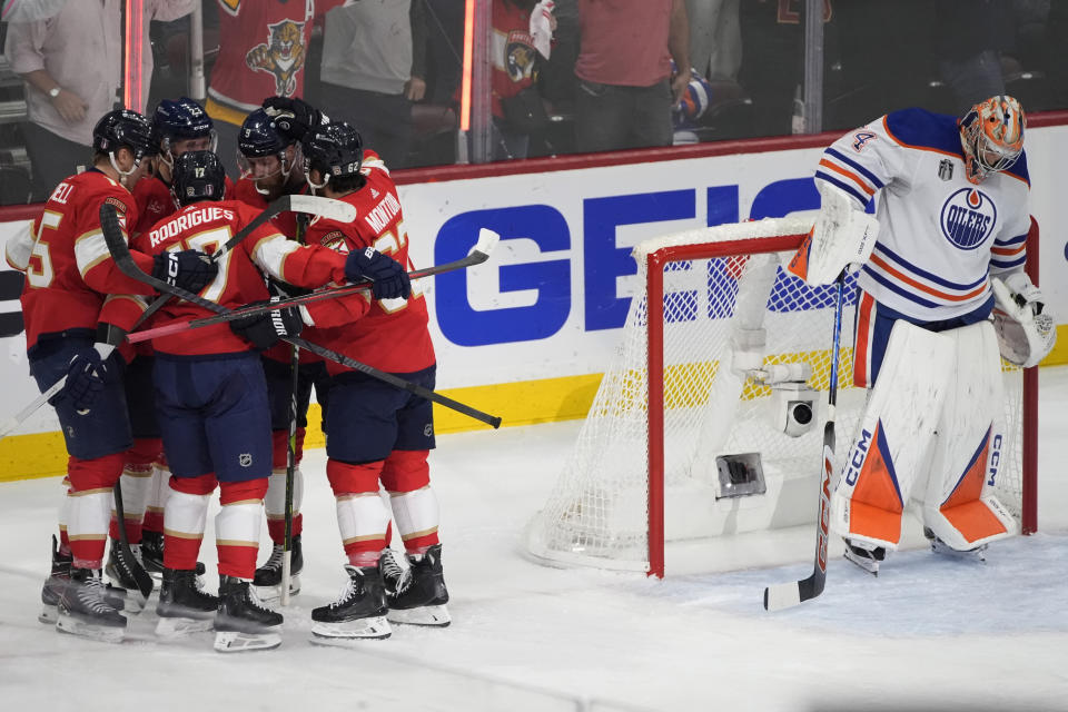 Florida Panthers teammates celebrate with Carter Verhaeghe (23) after he scored a goal during the first period of Game 7 of the NHL hockey Stanley Cup Final against the Edmonton Oilers, Monday, June 24, 2024, in Sunrise, Fla. (AP Photo/Rebecca Blackwell)