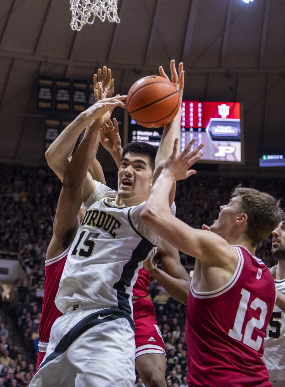 Purdue center Zach Edey (15) battles for a rebound with Indiana forward Miller Kopp (12) during the first half of an NCAA college basketball game, Saturday, March 5, 2022, in West Lafayette, Ind. (AP Photo/Doug McSchooler)