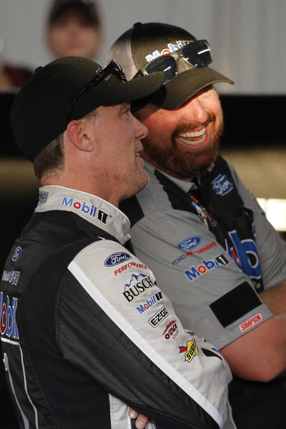 Kevin Harvick, left, talks with a crew member as he watches qualifying results for a NASCAR Monster Energy Cup auto race at Richmond Raceway in Richmond, Va., Friday, Sept. 20, 2019. (AP Photo/Steve Helber)