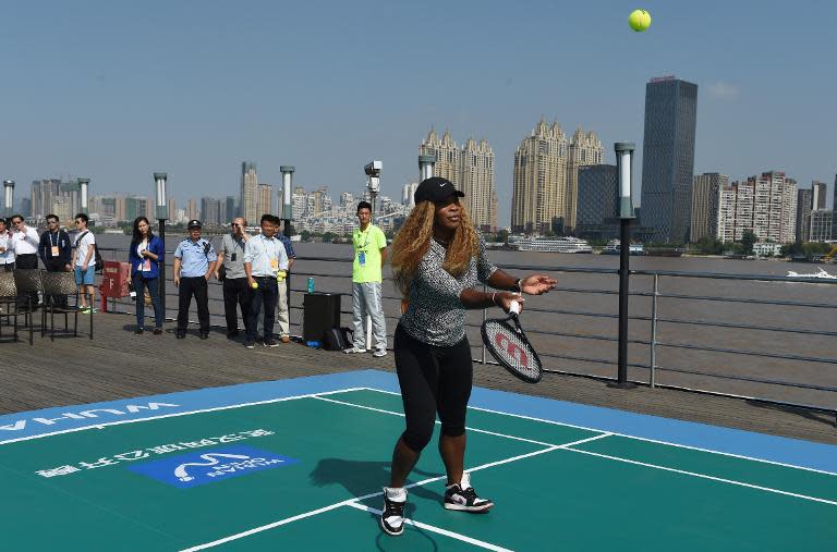 Serena Williams of the US plays tennis onboard a boat on the Yangtze River during a promotional event for the Wuhan Open tennis tournament in Wuhan, in China's Hubei province on September 22, 2014