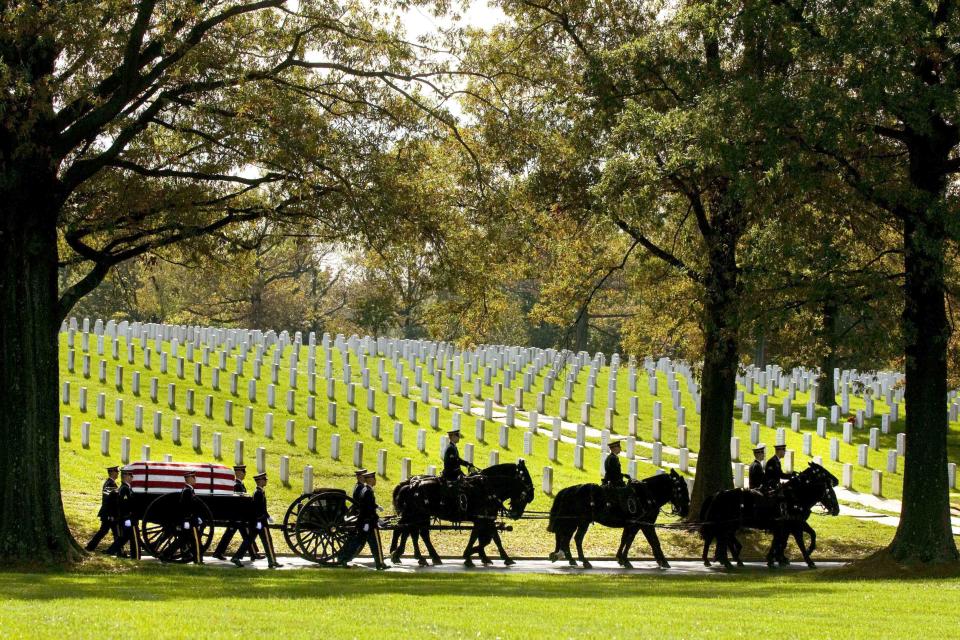 FILE - A U.S. Army Caisson team carries the remains of Army Pfc. Tramaine J. Billingsley during burial services at Arlington National Cemetery in Arlington, Va., Nov. 2, 2010. The Army has announced changes to the way it will care for the gray and black horses that carry service members' flag-draped coffins to their final resting places in Arlington National Cemetery. (AP Photo/Kevin Wolf, File)