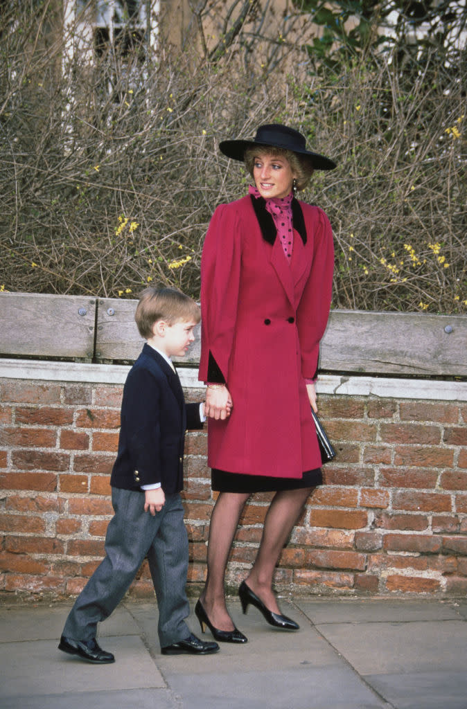 British royal Diana, Princess of Wales (1961-1997), wearing a red coat with black lapels and a black hat, and Prince William attend the Easter service at St George's Chapel in Windsor Castle, Windsor, Berkshire, England, 26th March 1989. (Photo by Princess Diana Archive/Getty Images)