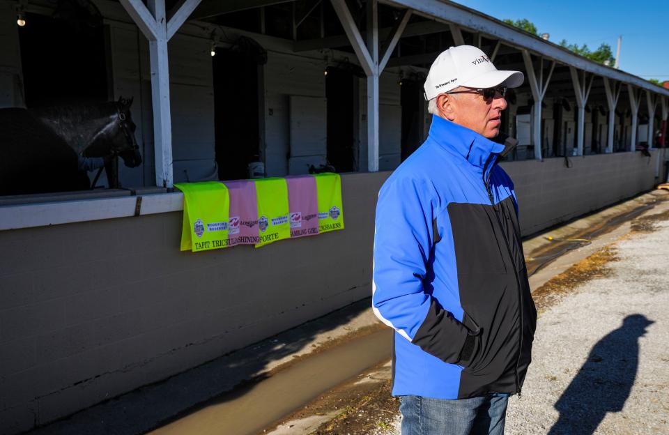 Trainer Todd Pletcher stands outside his barn as saddlecloths of three of his Kentucky Derby and two Kentucky Oaks horses hang to dry on the backside Wednesday morning at Churchill Downs May 3, 2023, in Louisville, Ky.
