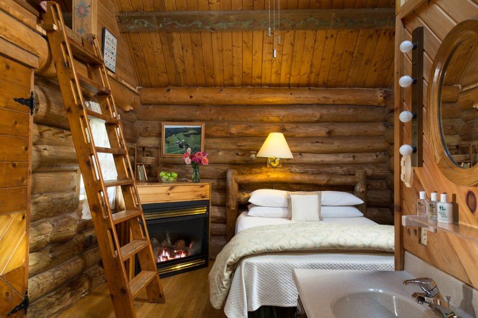 The Little House on the Prairie cabin at Justin Trails Resort in Sparta has a queen-size bed and fireplace on its main level, with a ladder leading to a loft with a whirlpool tub.