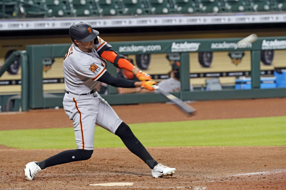 San Francisco Giants' Hunter Pence hits a three-run home run against the Houston Astros during the seventh inning of a baseball game Tuesday, Aug. 11, 2020, in Houston. (AP Photo/David J. Phillip)