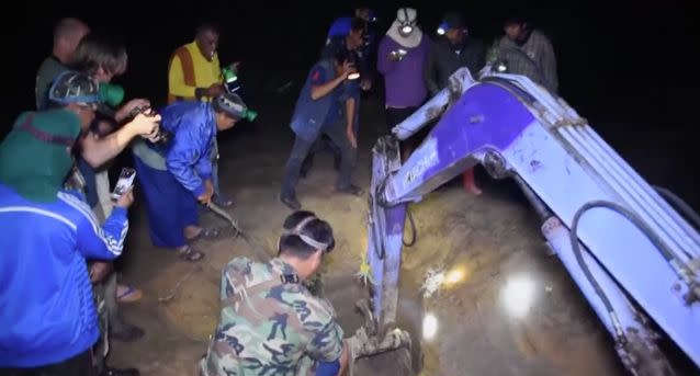 The rescuers arrived to help dig the one-year-old calf out of the hole. Source: Department of National Parks, Wildlife and Plant Conservation via Storyful