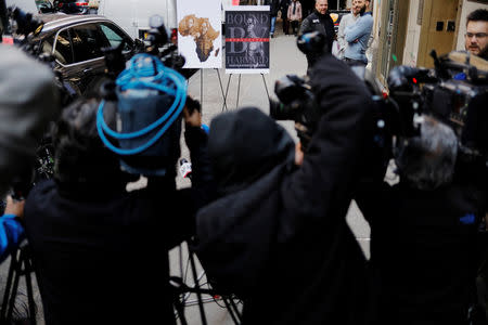 Members of the media record footage of images mentioned in a lawsuit by Tamara Lanier accusing Harvard University of the monetization of photographic images of her great-great-great grandfather, an enslaved African man named Renty, and his daughter Delia, outside of the Harvard Club in New York, U.S., March 20, 2019. REUTERS/Lucas Jackson