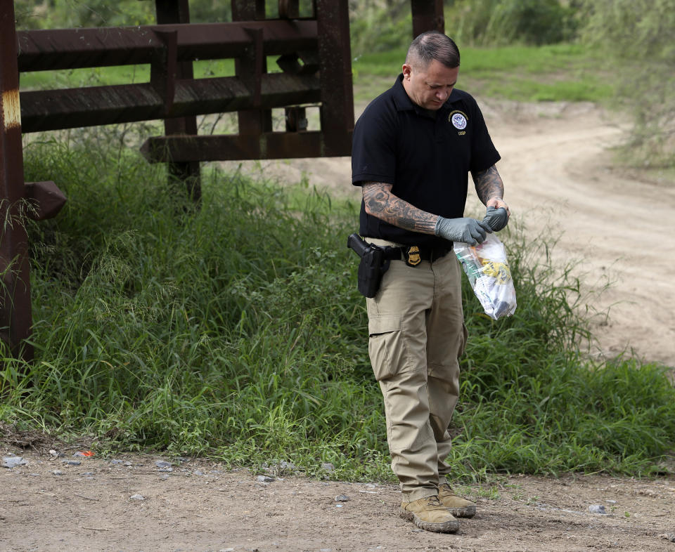 A border patrol officer works on the scene where an off duty border patrol agent involved in an ATV vehicle crash was killed on Wednesday Dec. 7, 2022 in Mission, Texas. (Delcia Lopez/The Monitor via AP)