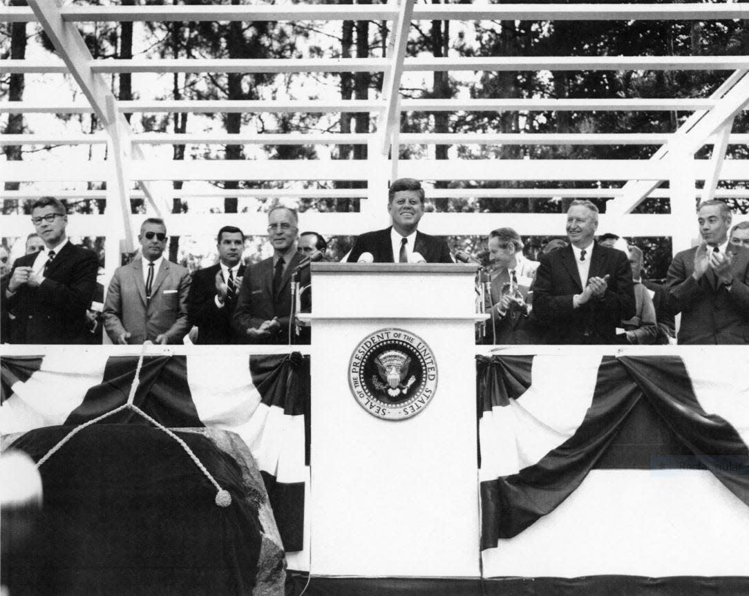 President John F. Kennedy at the podium at Grey Towers National Historic Site, September 24, 1963, where he dedicated the Pinchot Institute for Conservation Studies. At far right is Pennsylvania Governor William Scranton.