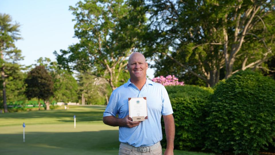 Brendan Hester poses with the plaque he was awarded after he qualified for the US Senior Open qualifier.