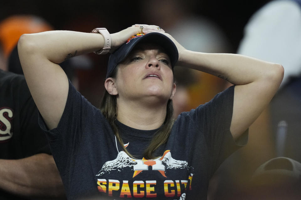 A Houston Astros fan watches during the eighth inning of Game 1 in baseball's World Series between the Houston Astros and the Atlanta Braves Tuesday, Oct. 26, 2021, in Houston. (AP Photo/David J. Phillip)