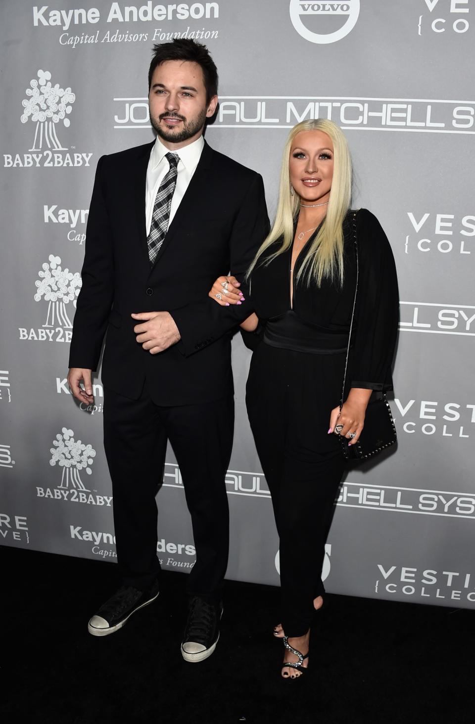 <p>Christina manned up for the event in a black jumpsuit with sparkly sandals and a lust-worthy choker. <i>[Photo: Getty]</i> </p>