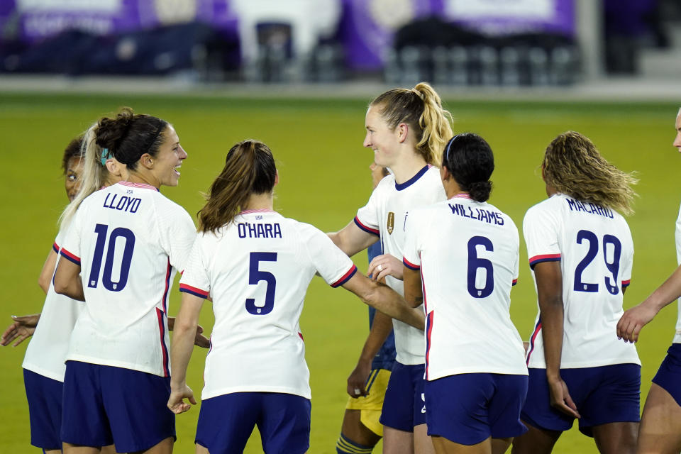 United States midfielder Samantha Mewis, center, celebrates after scoring a goal against Colombia on a penalty kick with teammates forward Carli Lloyd, defender Kelly O'Hara (5), forward Lynn Williams (6), and defender Catrina Macario (29) during the second half of an international friendly soccer match, Monday, Jan. 18, 2021, in Orlando, Fla. (AP Photo/John Raoux)