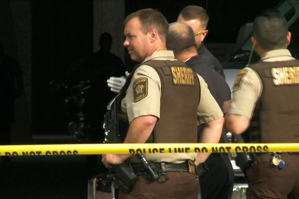 Police officers investigate a shooting in Minneapolis on Thursday. (KARE)