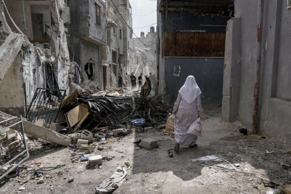 Palestinians inspect the destruction following an Israeli military raid in Nur Shams refugee camp, near the West Bank town of Tulkarem, Sunday, April 21, 2024. The Palestinian Red Crescent rescue service said 14 bodies have been recovered from the Nur Shams urban refugee camp since an Israeli military operation began in the area Thursday night. The Islamic Jihad militant group confirmed the deaths of three members. Another killed was a 15-year-old boy. The Israeli army said its forces killed 10 militants in the camp and surrounding areas while eight suspects were arrested. (AP Photo/Majdi Mohammed)