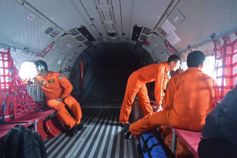 Indonesian air force CN295 crew members during the search operation for missing AirAsia flight QZ8501 over waters near Pangkalan, Central Kalimantan, on December 30, 2014