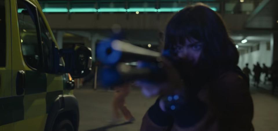 Miranda aiming a gun outside a hospital in "The Gray Man"