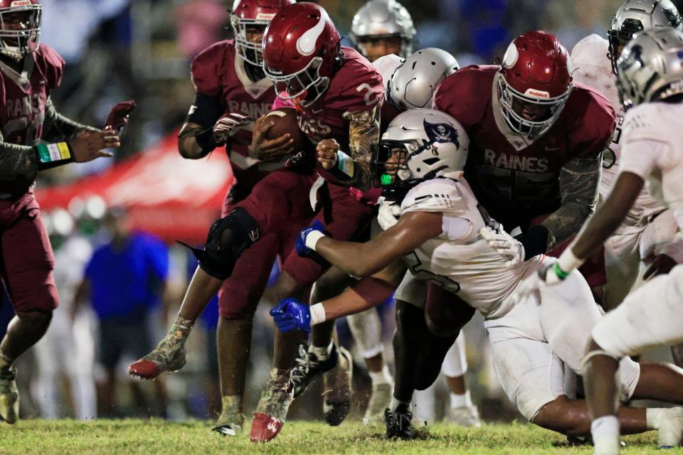 Raines' quarterback Ty'ren Randolph (2) rushes for yards on a keeper setting the team up for a touchdown in the fourth quarter of the Vikings' 27-26 win over First Coast.