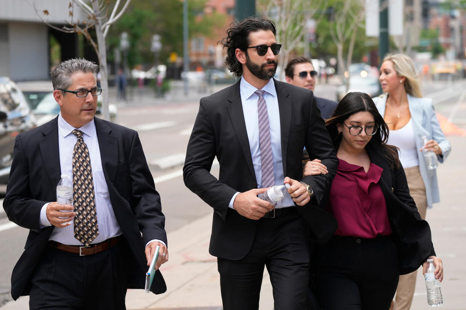A defense investigator, left, for Pittsburgh dentist Lawrence “Larry” Rudolph heads into federal court with the dentist’s children, front center and back right, for the afternoon session of the trial, Wednesday, July 13, 2022, in Denver. - Credit: David Zalubowski/AP Photo