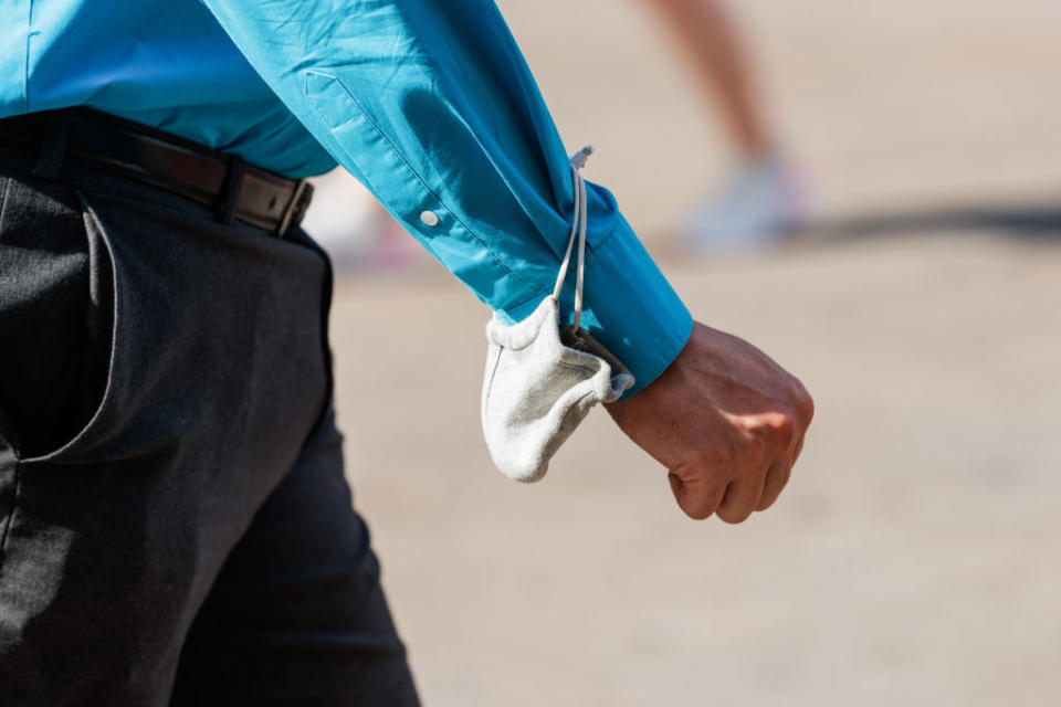  BERLIN, July 26, 2020  -- A man walks with a face mask on his wrist in Berlin, capital of Germany, July 25, 2020.   Registered COVID-19 cases in Germany increased by 815 on Friday and 781 on Saturday, according to the Robert Koch Institute. (Photo by Binh Truong/Xinhua via Getty)