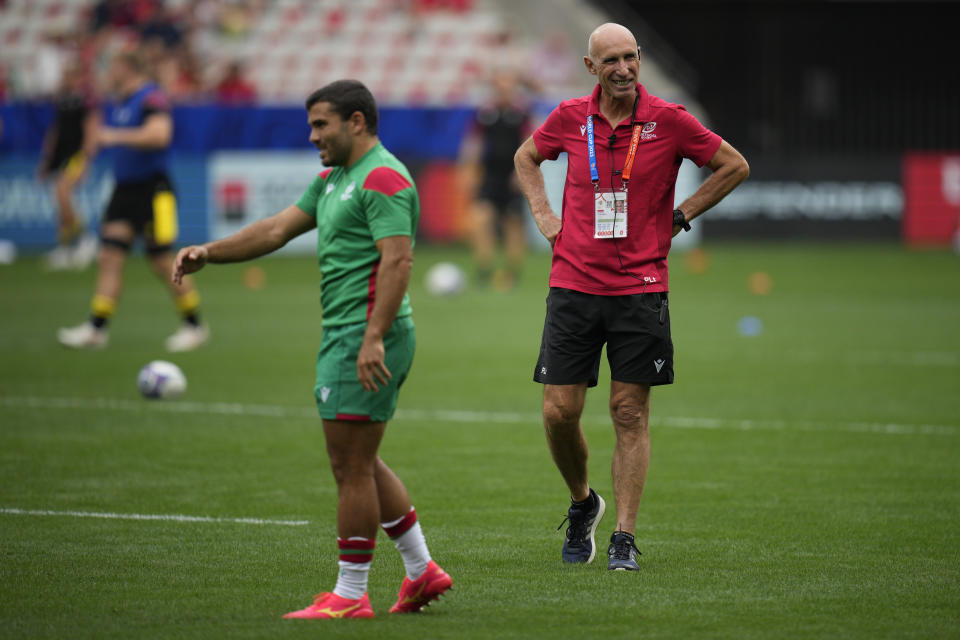 Portugal's head coach Patrice Lagisquet, right, attends the warm up session before the Rugby World Cup Pool C match between Wales and Portugal at the Stade de Nice, Saturday, Sept. 16, 2023 in Nice, southern France. (AP Photo/Daniel Cole)