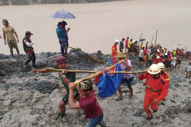 People carry a dead body following a landslide at a mining site in Phakant, Kachin State City, Myanmar July 2, 2020: MFSD via Reuters