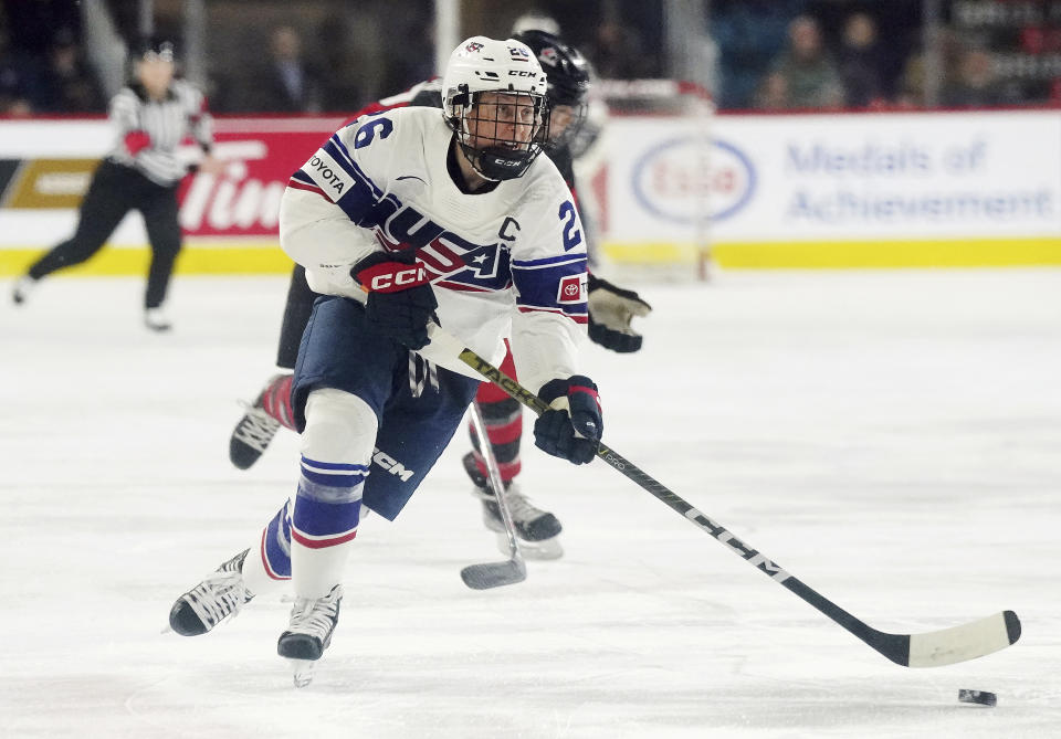 FILE - United States' Kendall Coyne Schofield skates with the puck against Canada during the first period of a Rivalry Series hockey game Nov. 17, 2022, in Kamloops, British Columbia. Coyne Schofield, a three-time Olympian and former U.S. captain, will suit up for Minnesota’s Professional Women's Hockey League opener at Boston on Jan. 3. The game will underline Coyne Schofield’s determination in returning to competitive play, after the birth of her son, now 6 months old. (Jesse Johnston/The Canadian Press via AP, File, File)