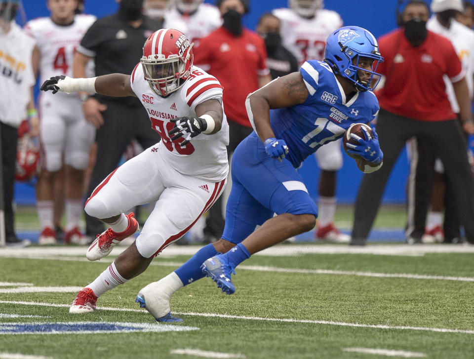 Georgia State running back Destin Coates (17) dodges a tackle from Louisiana-Lafayette linebacker Jasper Williams (36) in the first half of an NCAA college football game, Saturday, Sept. 19, 2020, in Atlanta. (Daniel Varnado/Atlanta Journal-Constitution via AP)