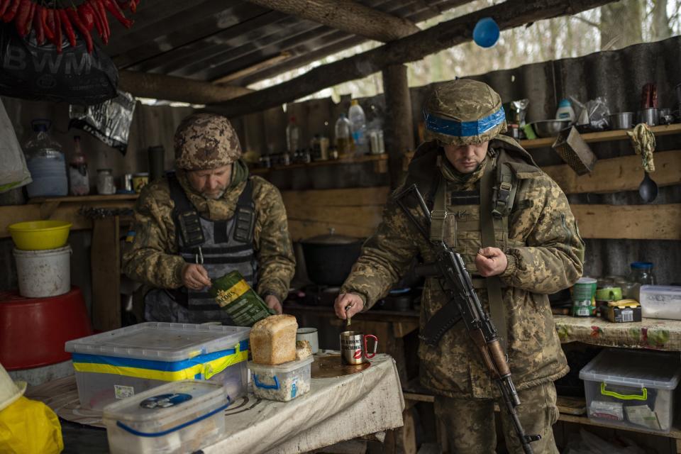 FILE - Soldiers of Ukraine's state border guard have a break for tea at a military position in the Sumy region of Ukraine, Friday, Nov. 24, 2023. After blunting Ukraine's counteroffensive from the summer, Russia is building up its resources for a new stage of the war over the winter, which could involve trying to extend its gains in the east and deal significant blows to the country's vital infrastructure. Russia has ramped up its pressure on Ukrainian forces on several parts of the more than 1,000-kilometer (620-mile) front line. (AP Photo/Hanna Arhirova, File)