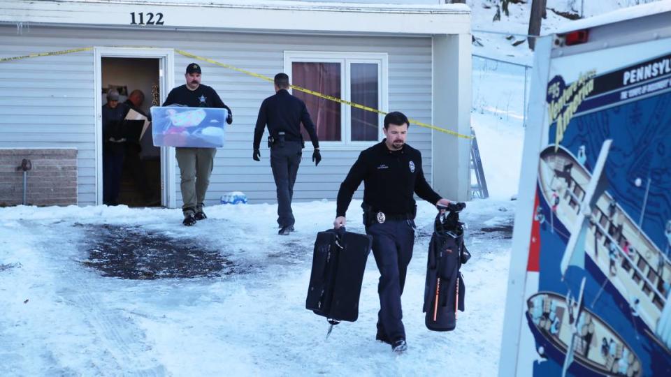 Moscow Police Capt. Anthony Dahlinger, right, and other members of law enforcement pack and remove the personal belongings of the University of Idaho homicide victims from their rental house to return to their families, on Dec. 7.